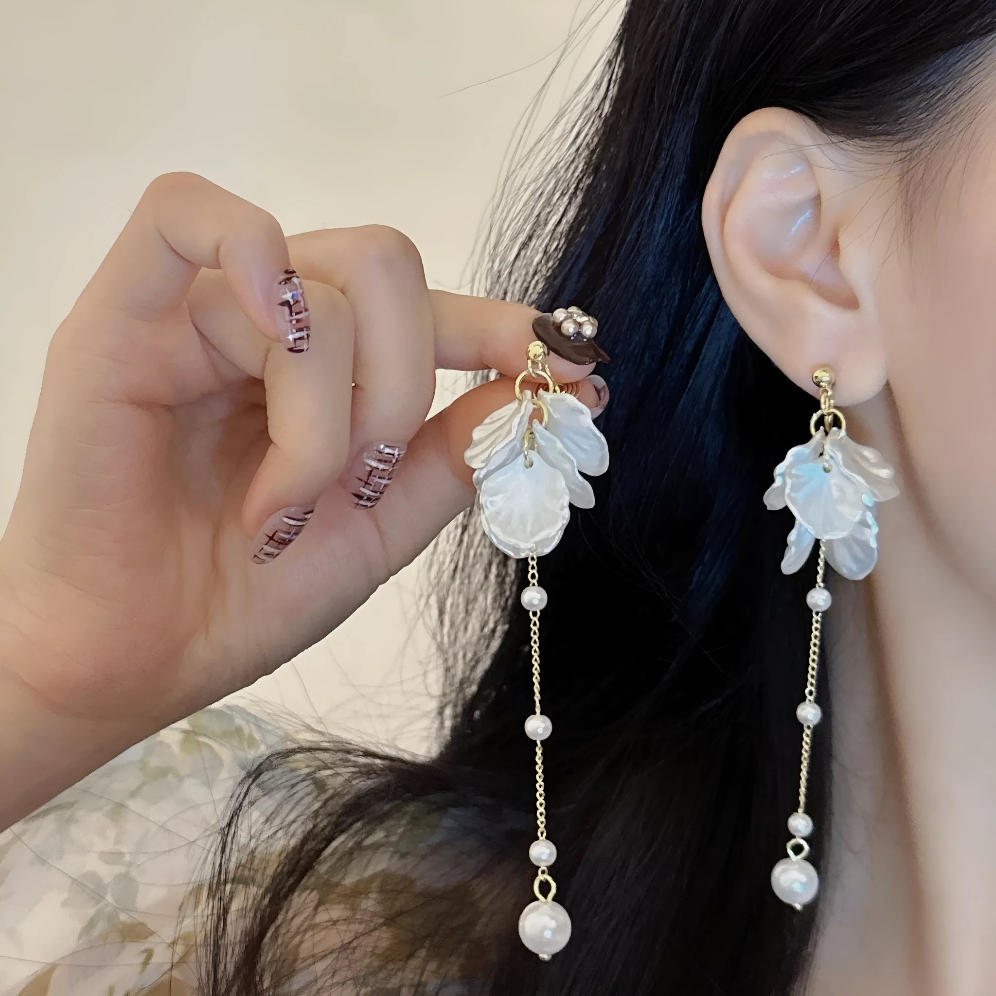 Women's shell pearl tassel earrings with acrylic construction and choice of ear clip types