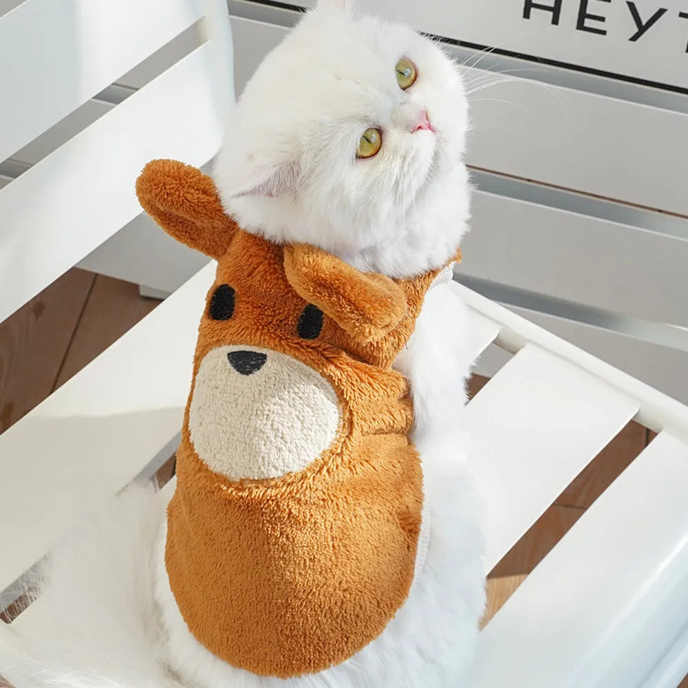 Fleece-lined warm polyester dog coat in cream with bear ears, lying flat showing size tag