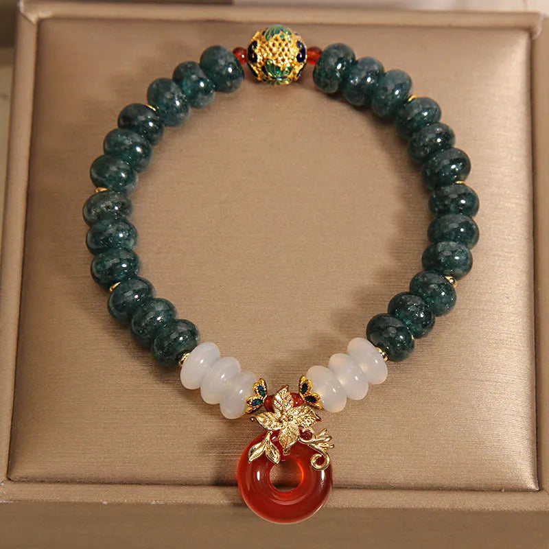 Blue water jade and red agate bracelet with crystal beads and a peace buckle closure