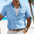Man wearing a loose grey cotton cardigan-style shirt with a polo collar and long sleeves.