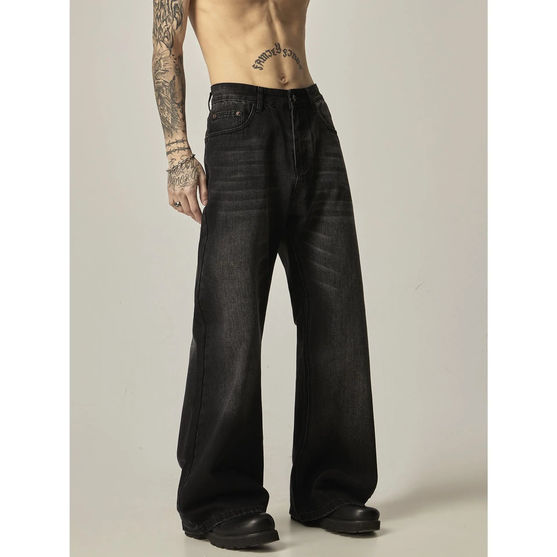 Black loose fit straight leg retro jeans on a hanger, showing zipper fly and relaxed silhouette.