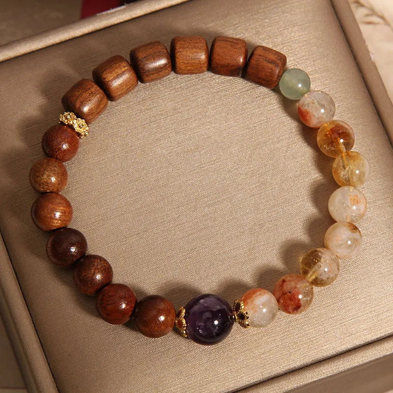 Women's bracelet with yellow crystal, amethyst, ebony, pearls, and rhinestones.