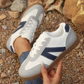 Blue women's low-top hiking training shoes with a lace-up front and rubber sole.