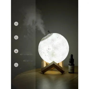 Spherical white Lunar humidifier night light with USB charging port and essential oil bottle