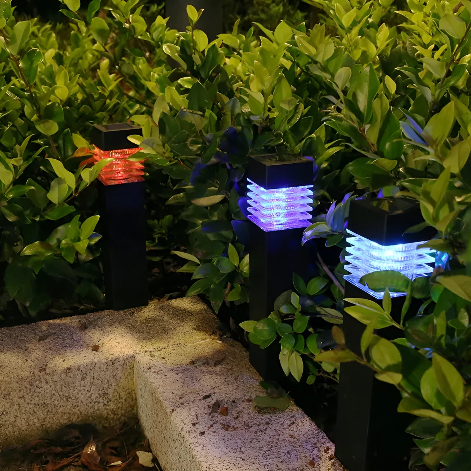 A tall, white, cuboid-shaped solar garden lamp with a ground spike, placed on a lawn.