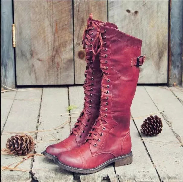 Women's black high leg boots with a chunky low heel and round toe on a solid background.