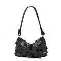 Women's polyester underarm shoulder bag in black colour showing sandwich pocket design and sewing thread detailing