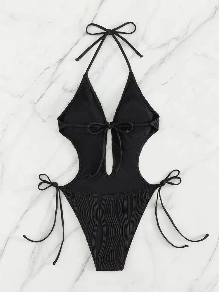 Black and white lace-up triangle bikini swimsuit for women on a size chart background