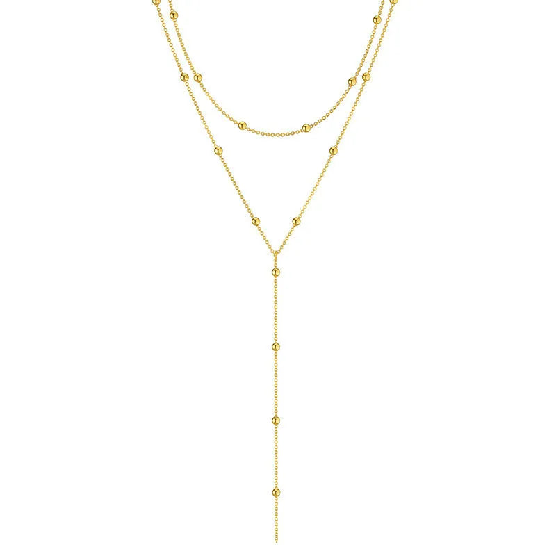 Fashion long necklace with geometric tassel and round beads in gold colour on clavicle chain