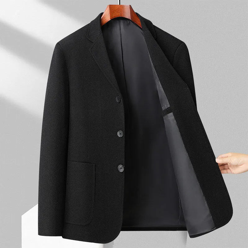 A man wearing a simple, solid-colour loose-fit suit coat for spring or autumn.