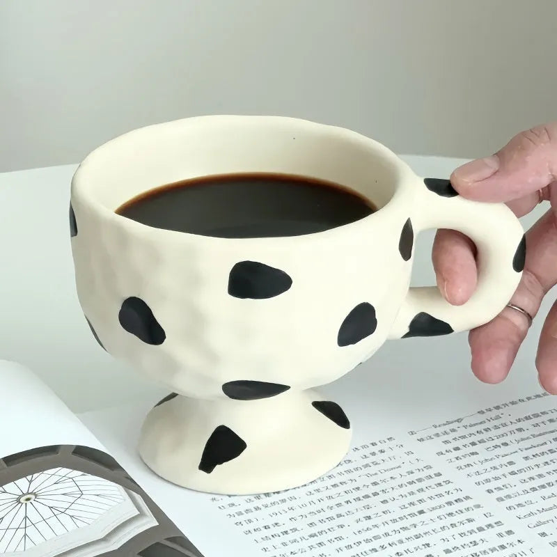 Hand-pinched ceramic mug with irregular shape and solid-colour finish, approximately 14.5cm tall