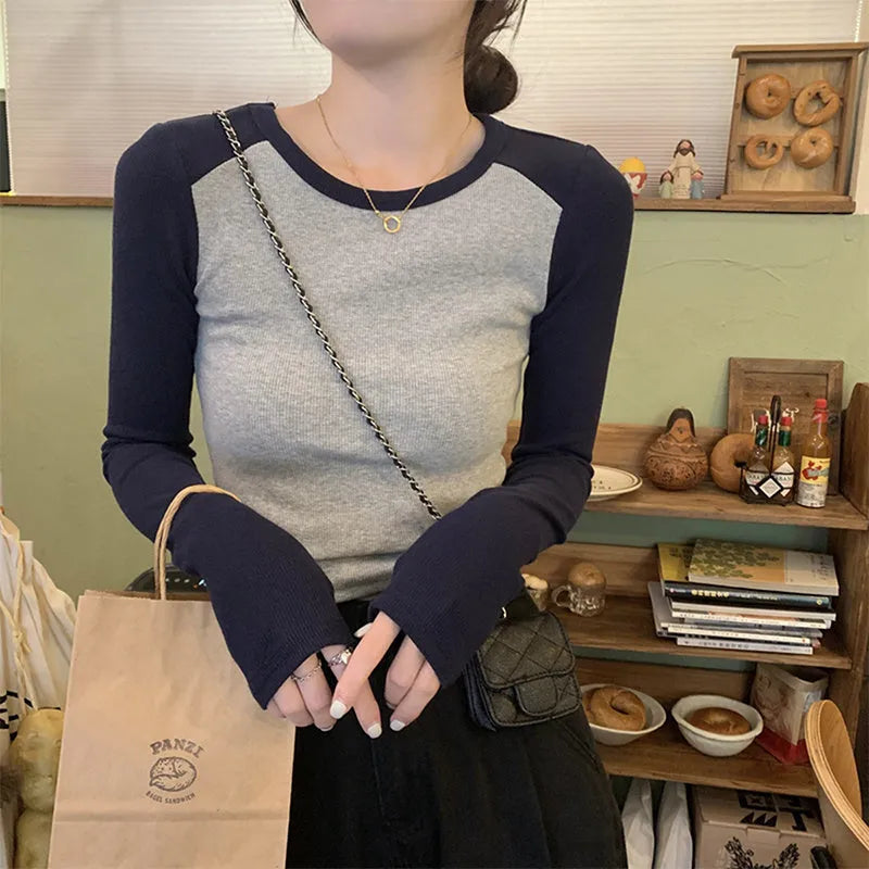 Women's dark blue viscose top with long princess sleeves and embroidery detail on front.