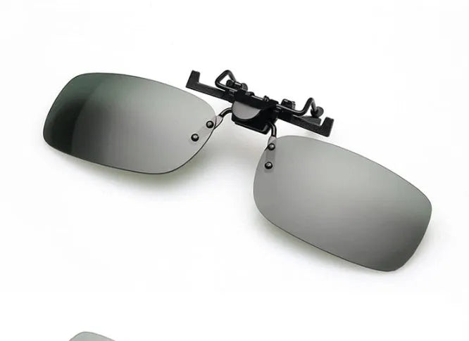 Clip-on night vision polarised sunglasses attached over a pair of prescription glasses for driving.