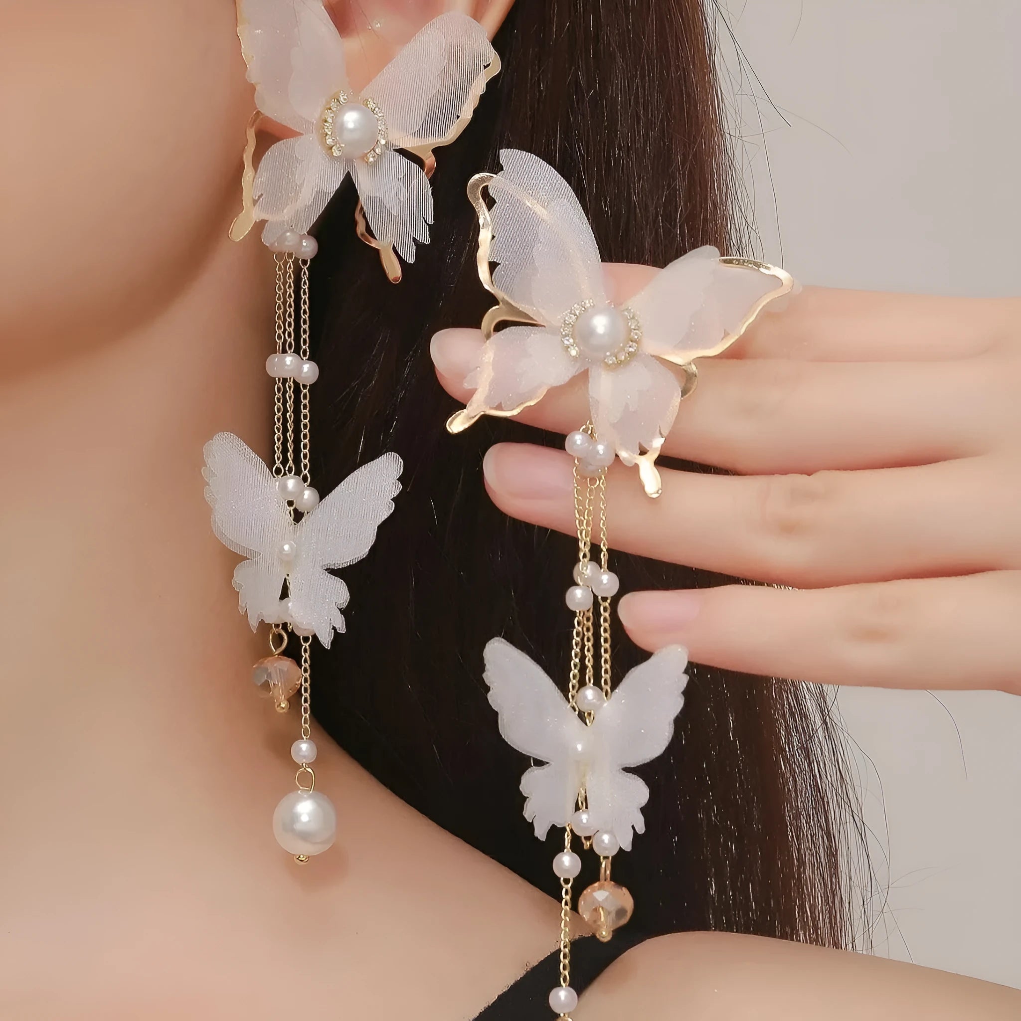 Women's white butterfly earrings with tassel design, lace pattern, and pearl rhinestone accents on electroplated copper alloy