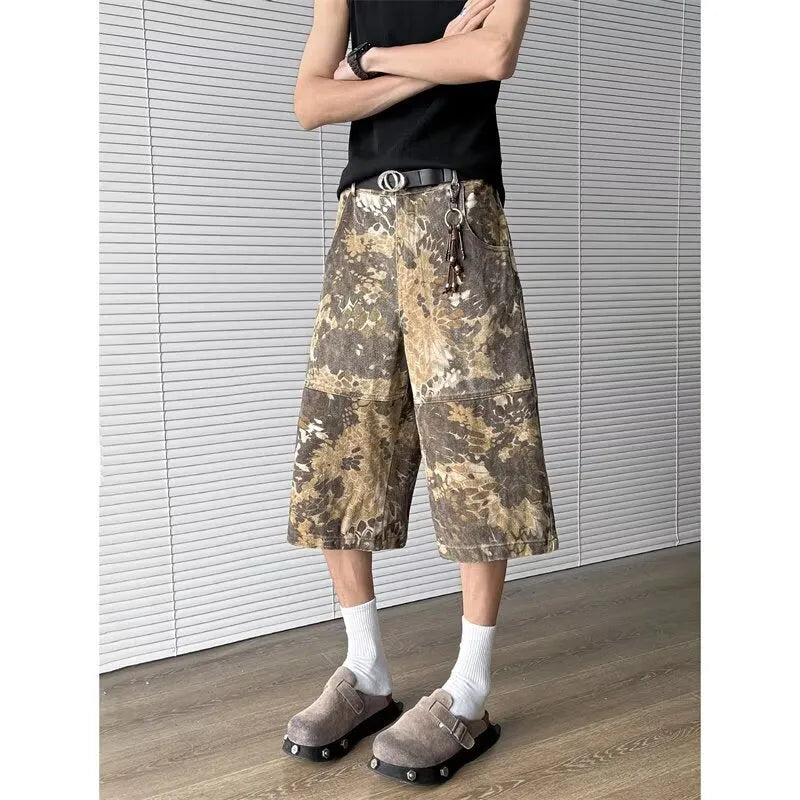 Yellow women's cropped jeans with a bold snake and camouflage pattern print on the legs.