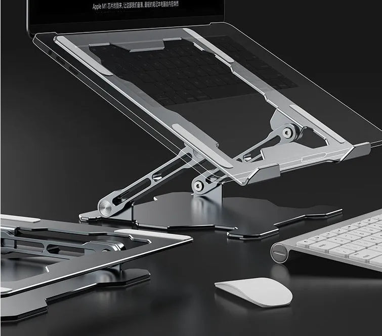 Grey aluminium adjustable laptop stand holding a silver laptop on a wooden desk.