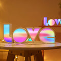 Colourful rainbow LED decorative light spelling LOVE, with USB cable, for Valentine's Day or wedding decor.