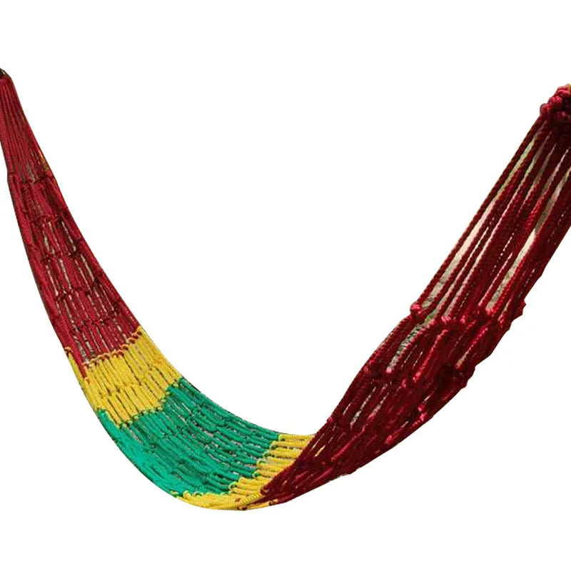 Outdoor nylon rope mesh hammock hung between two trees showing its woven construction and included tying ropes.