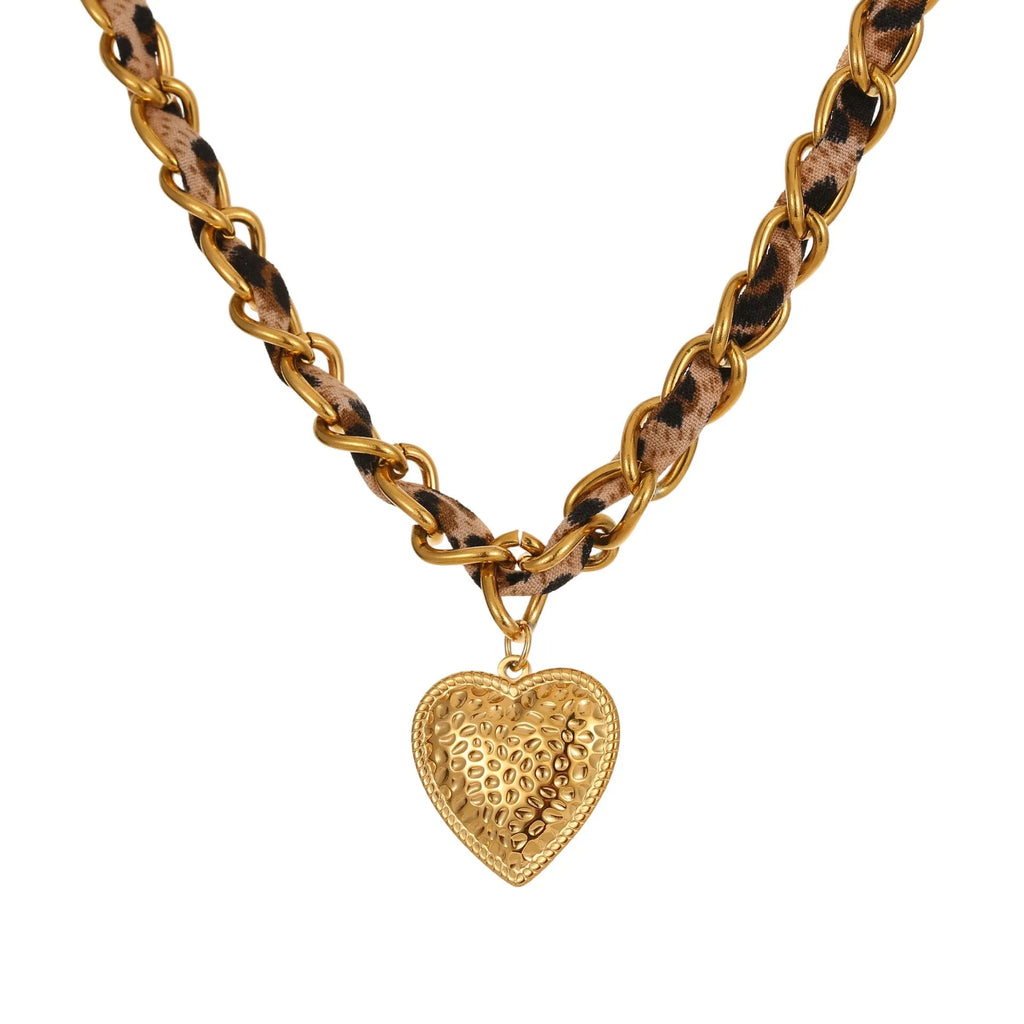 Gold plated leopard print stainless steel necklace with big heart or love sun pendant on a chain.