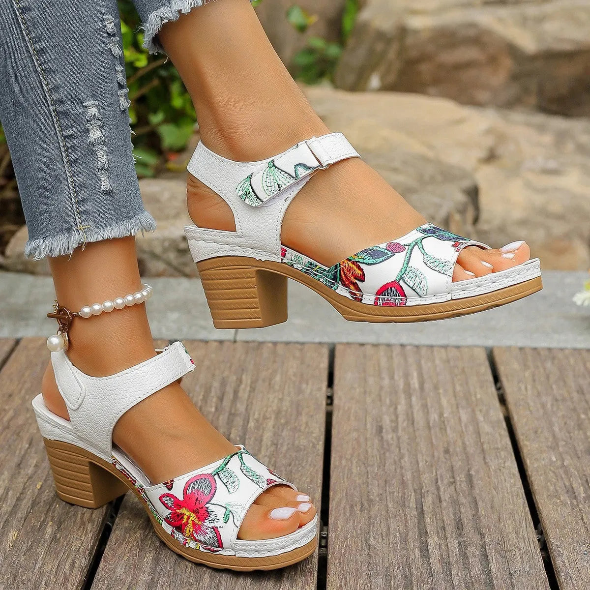 White women's high heel sandals with a Velcro strap buckle on a rubber sole.