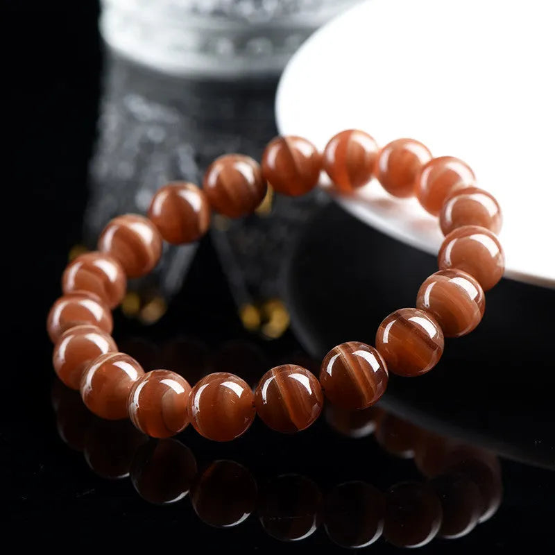 Natural old mine rhodochrosite round bead bracelet with Ruyi charm, Peruvian mineral jewellery.