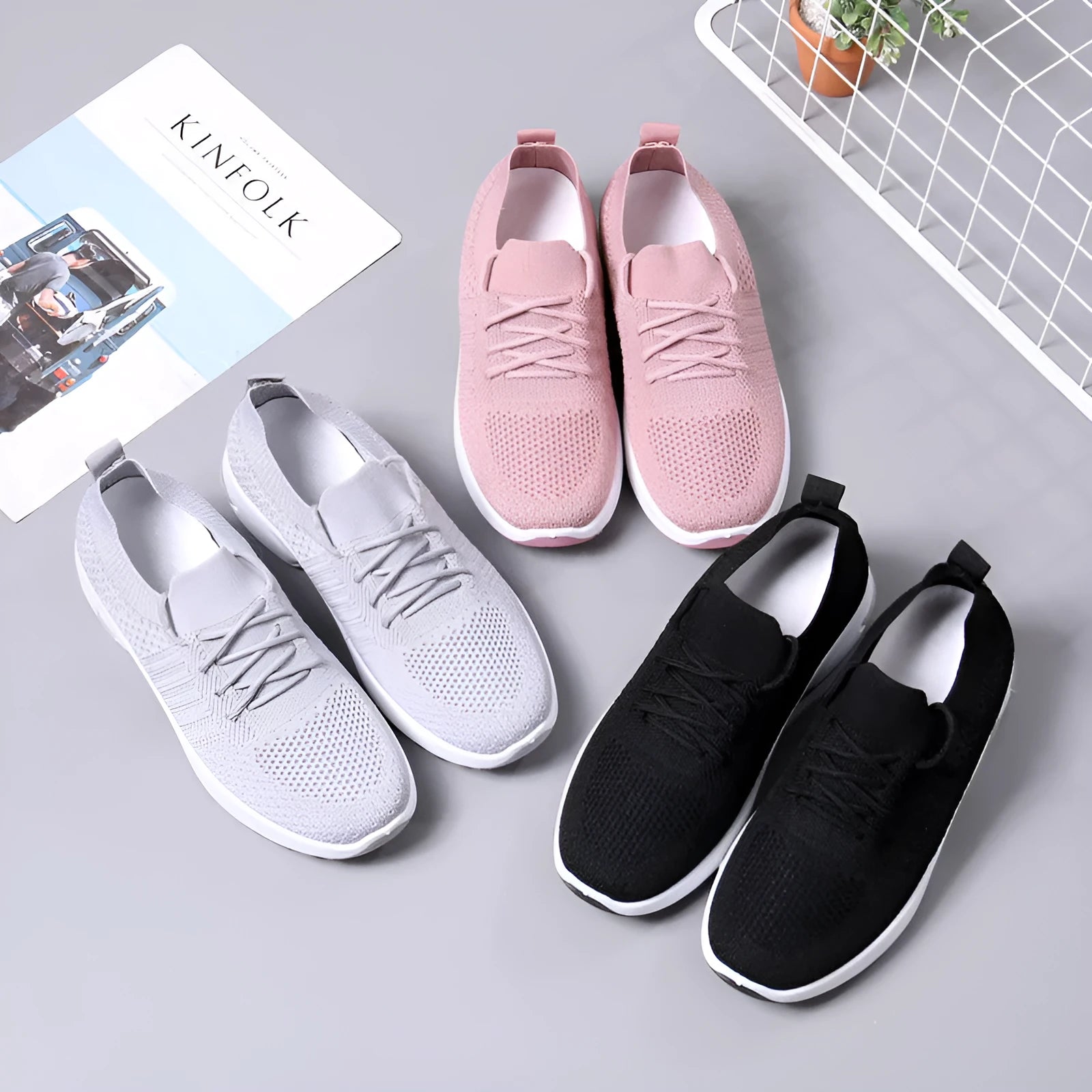 Women's black mesh sneakers with a soft sole and round toe, shown with lace-up front closure.