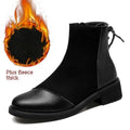 Women's black knee-high Martin boots with side zipper, round toe, and short stout heel.