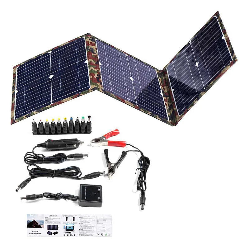 Black foldable 36W solar panel unfolded showing three monocrystalline silicon cells with car charger and USB accessories