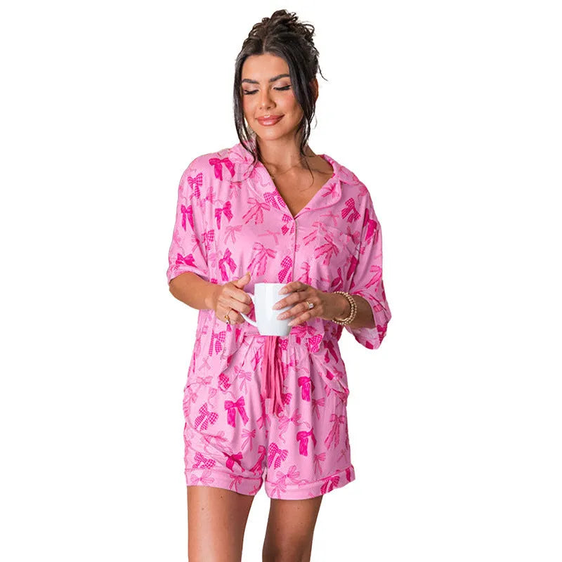 Pink bow print pyjama set with lightweight polyester fabric and simple two-piece design