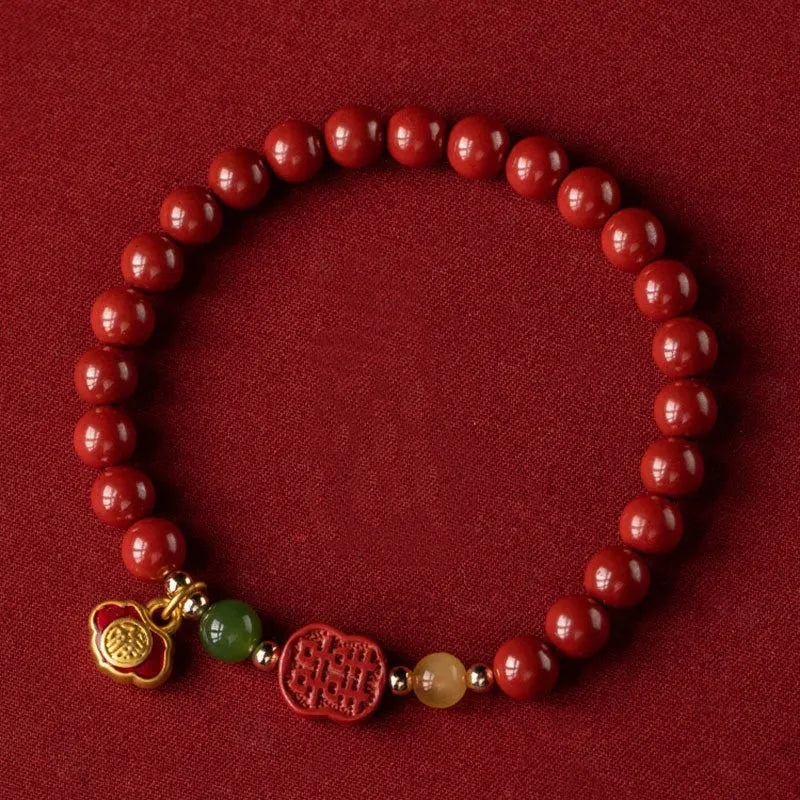 Happy Eyebrow bracelet made of raw Emperor Sandstone beads with a red Cinnabar and fu character charm.