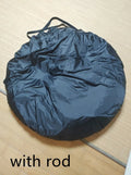 Black pop-up car tailgate camping tent unfolded next to a vehicle