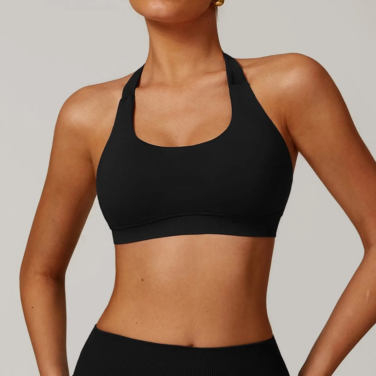 Women's halter style yoga sports bra in nylon fabric with removable padding