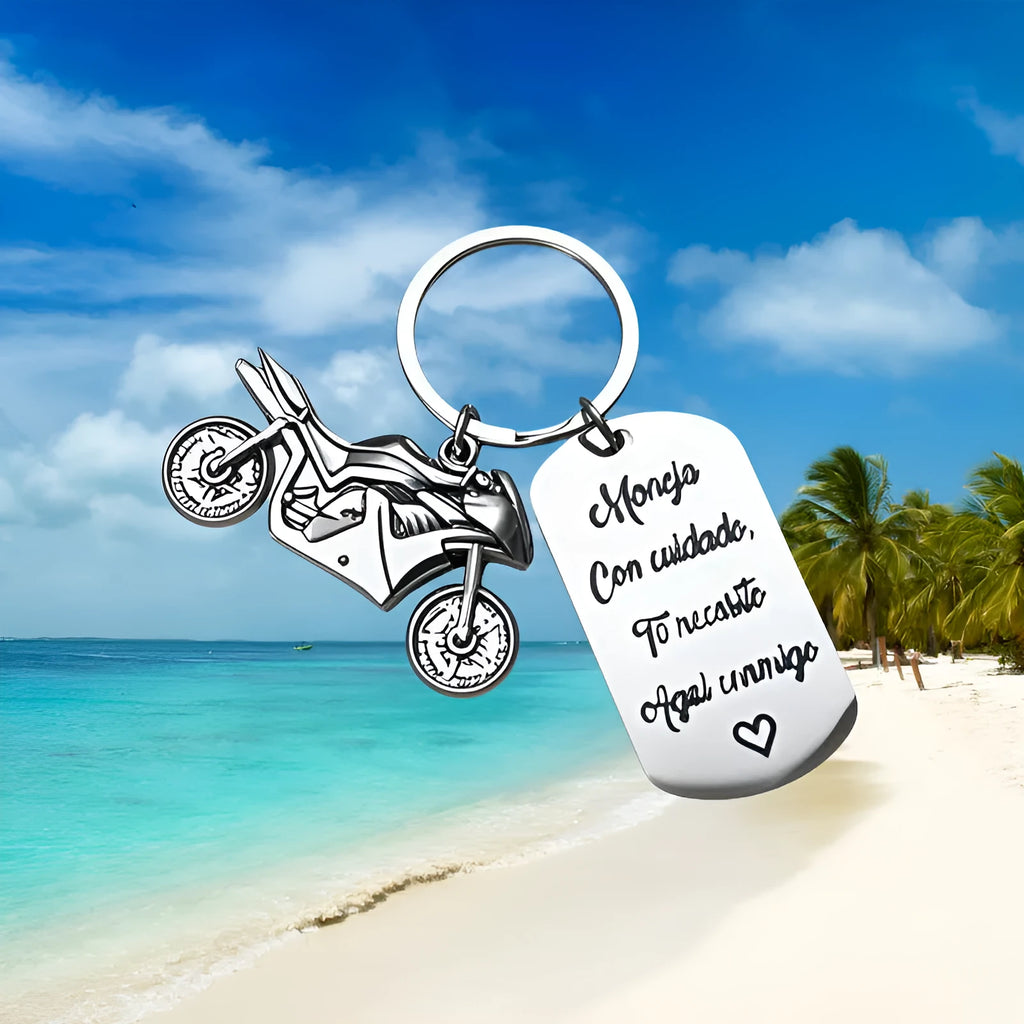Stainless steel motorcycle keychain with inspirational charm on a flannel bag.