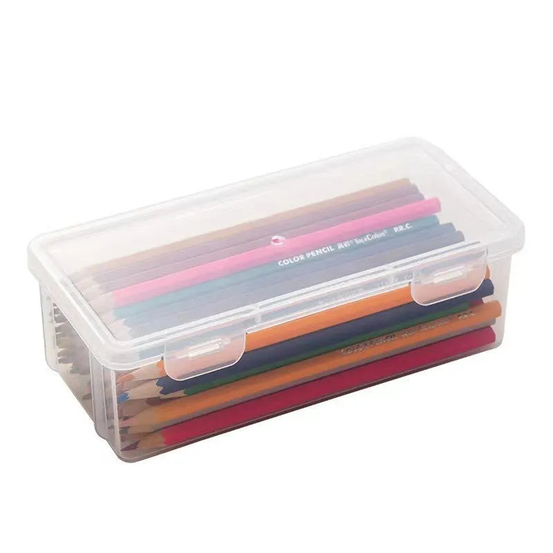 Transparent plastic stationery storage box with pencils and crayons inside