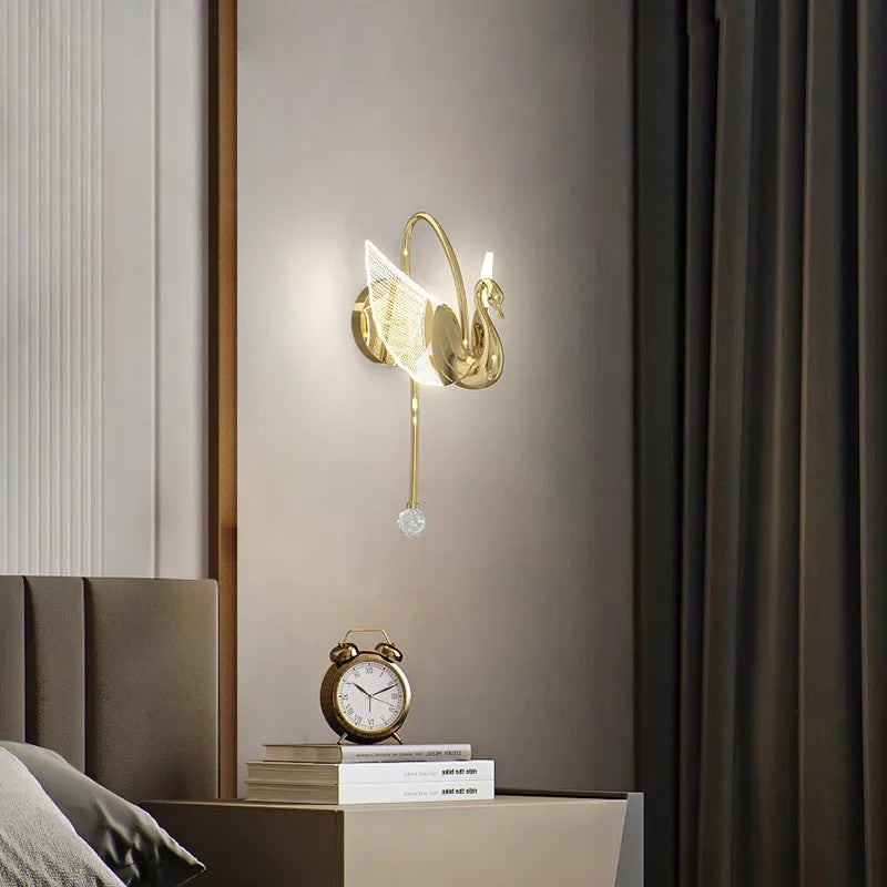 Gold swan-shaped LED wall lamp with acrylic shade and iron construction for bedroom lighting