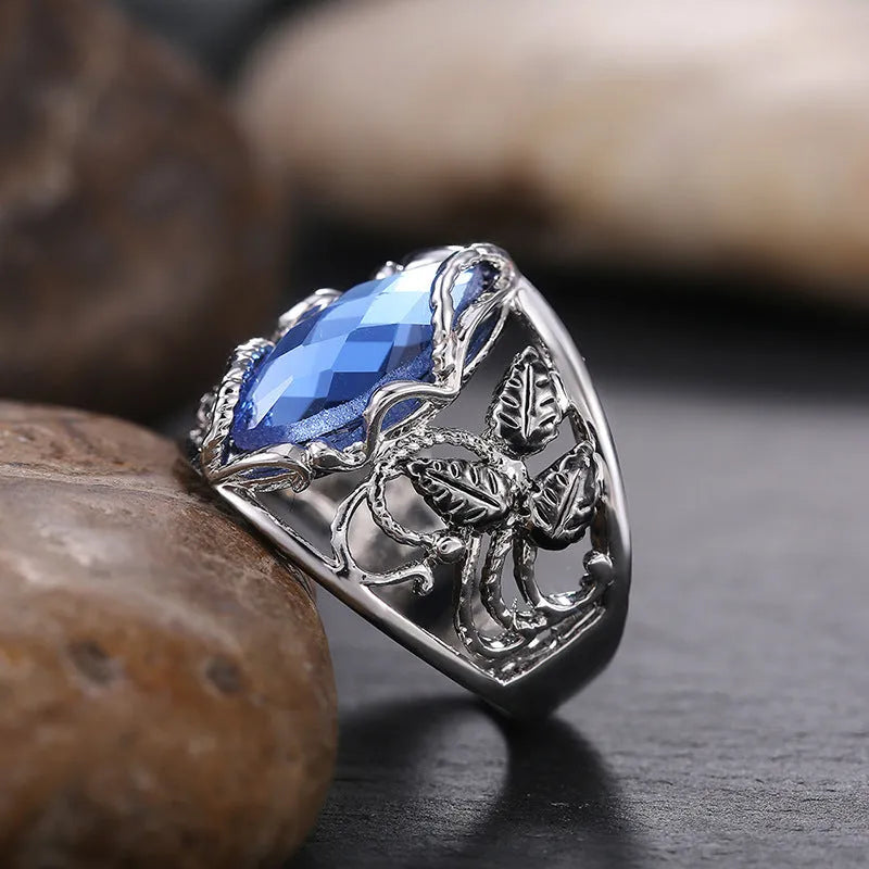 Blue crystal horse eye geometric ring on alloy band showing side profile