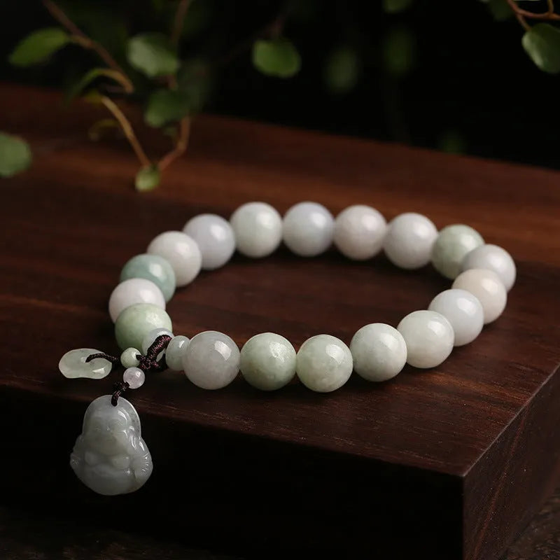Natural green jade bracelet with a hanging Maitreya Buddha charm on a wrist.