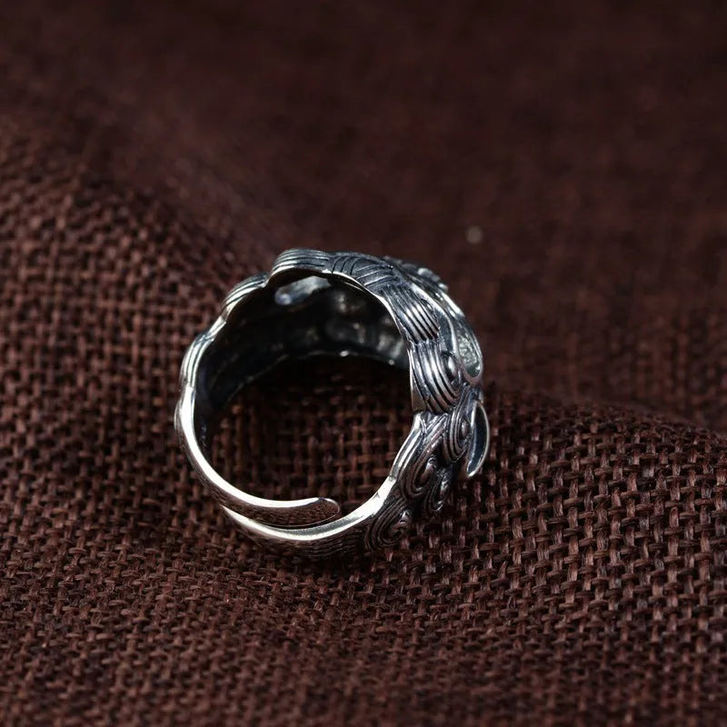 Silver open ring with a personalised diamond jibeast animal zodiac pattern on a hand.