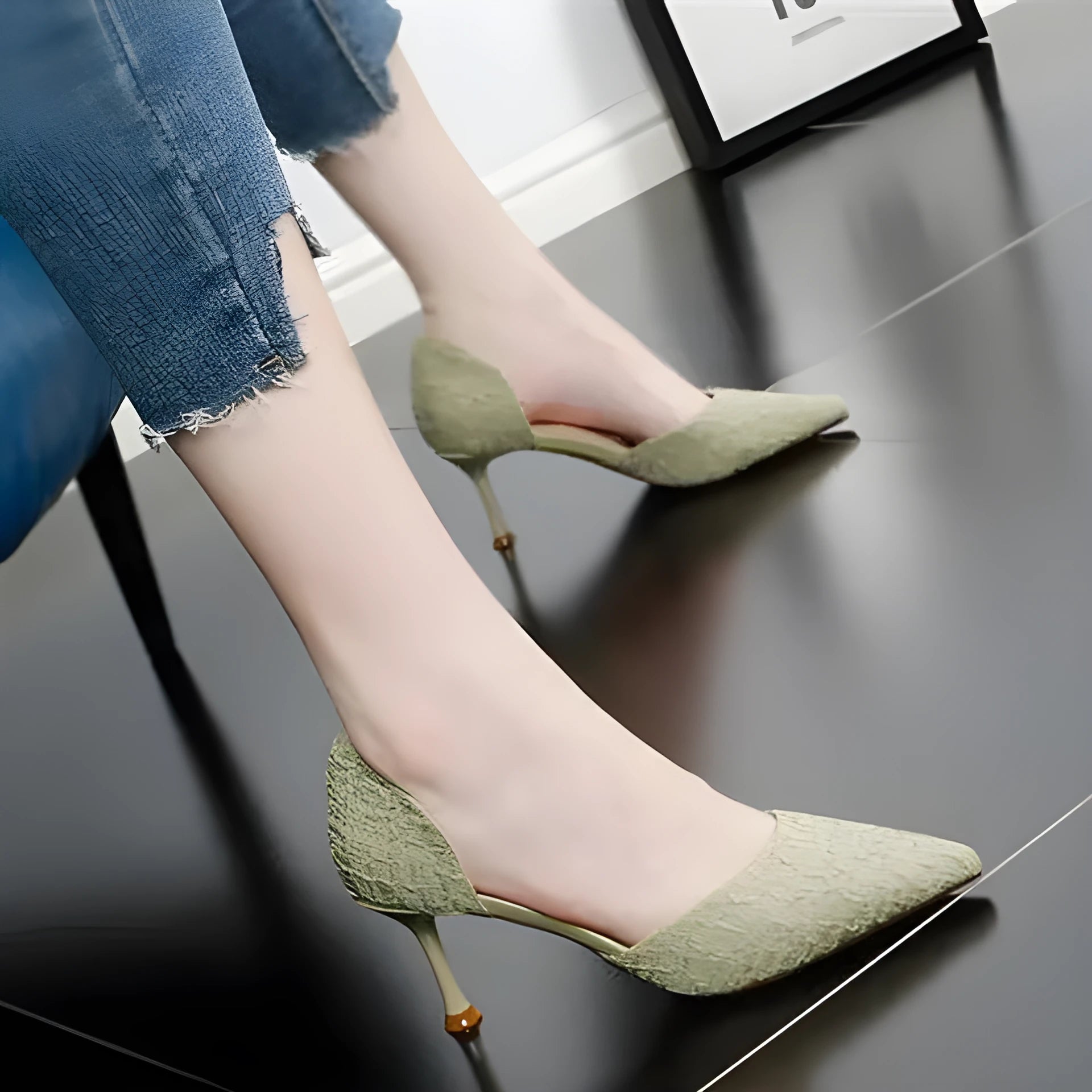 Women's black PU leather pointed toe stiletto high heels on a light background