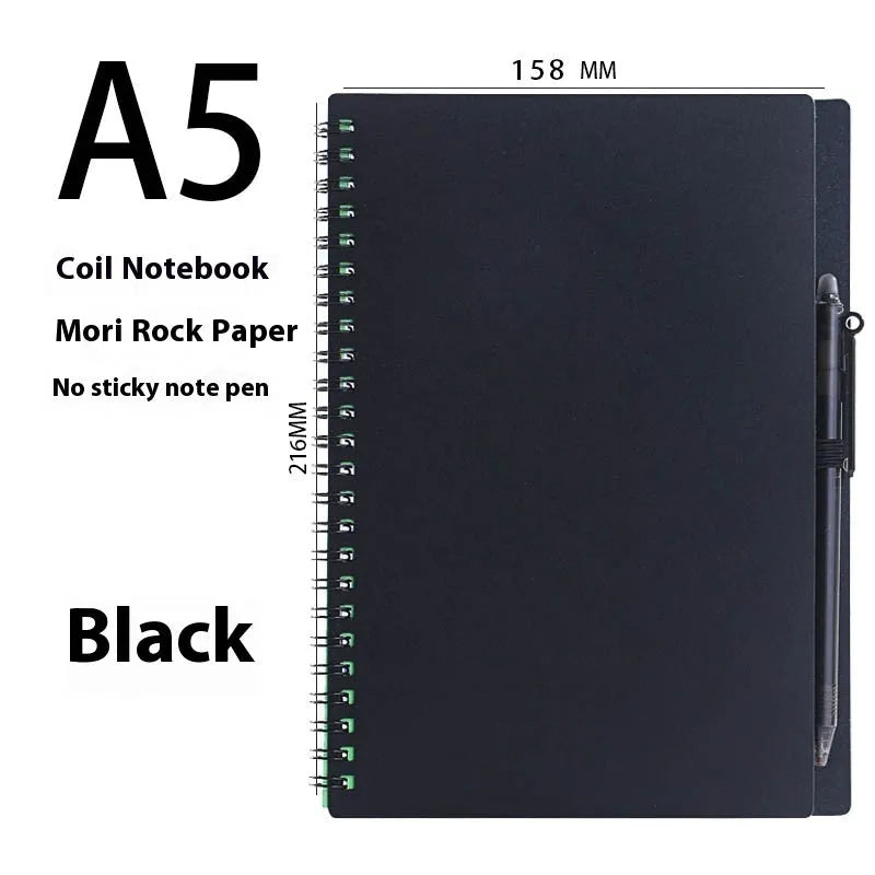 Erasable coil-bound notebook with stone paper, shown with pen and cloth on a wooden desk.