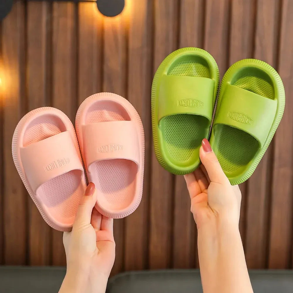Children's colourful EVA slippers showing non-slip sole, available in blue, green, orange, pink, and yellow.