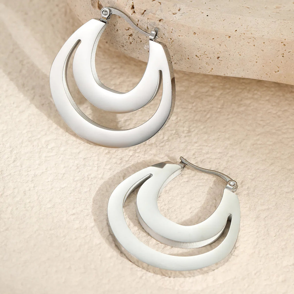 Geometric French earrings with gold plating and round ring elements on stainless steel