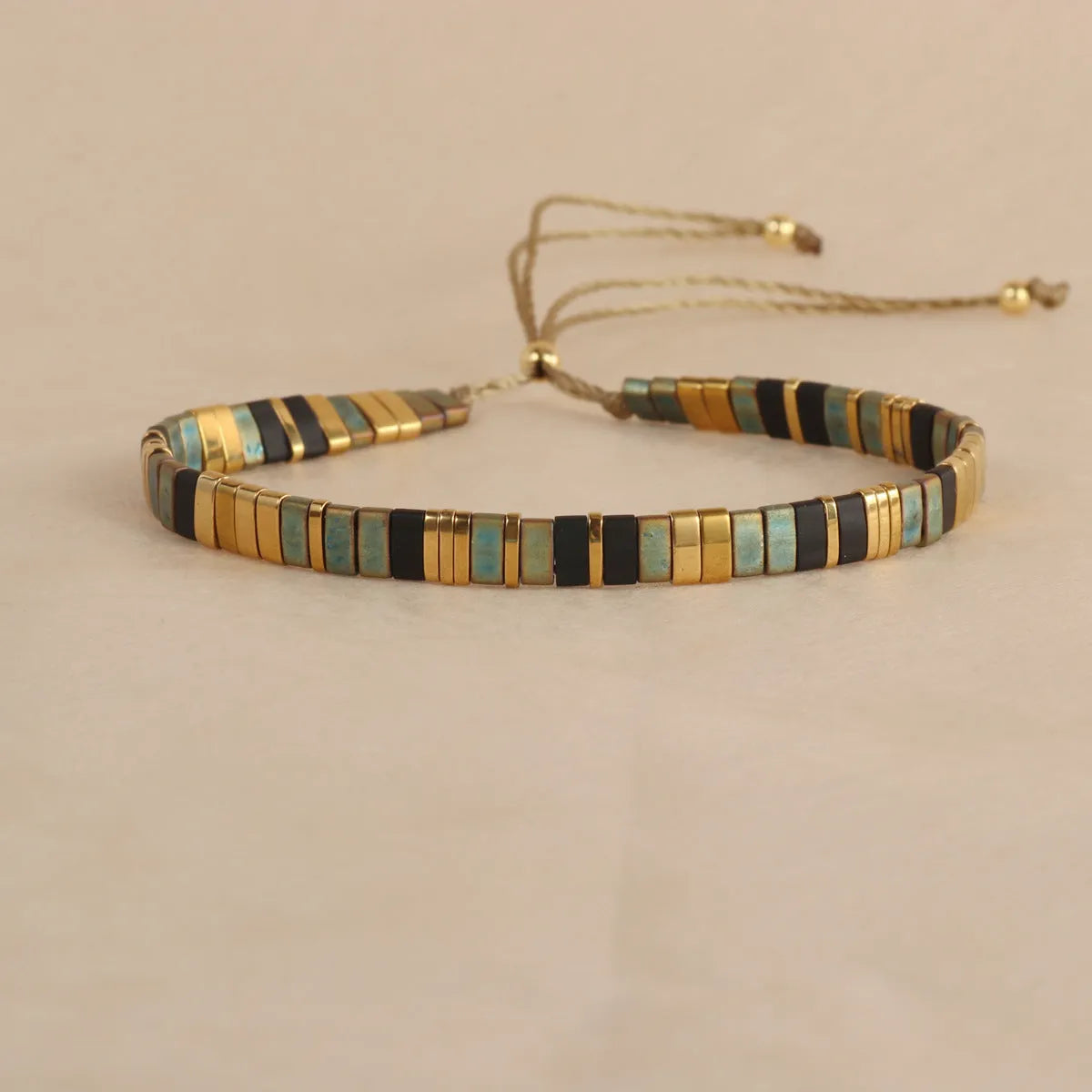 Adjustable glass beaded bracelet in geometric design with round beads available in five colours