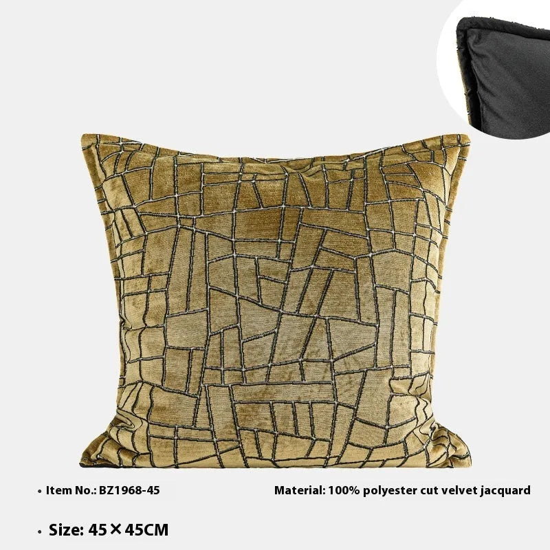 Gold geometric pattern polyester pillow cover shown in square and waist pillow sizes on a grey sofa.