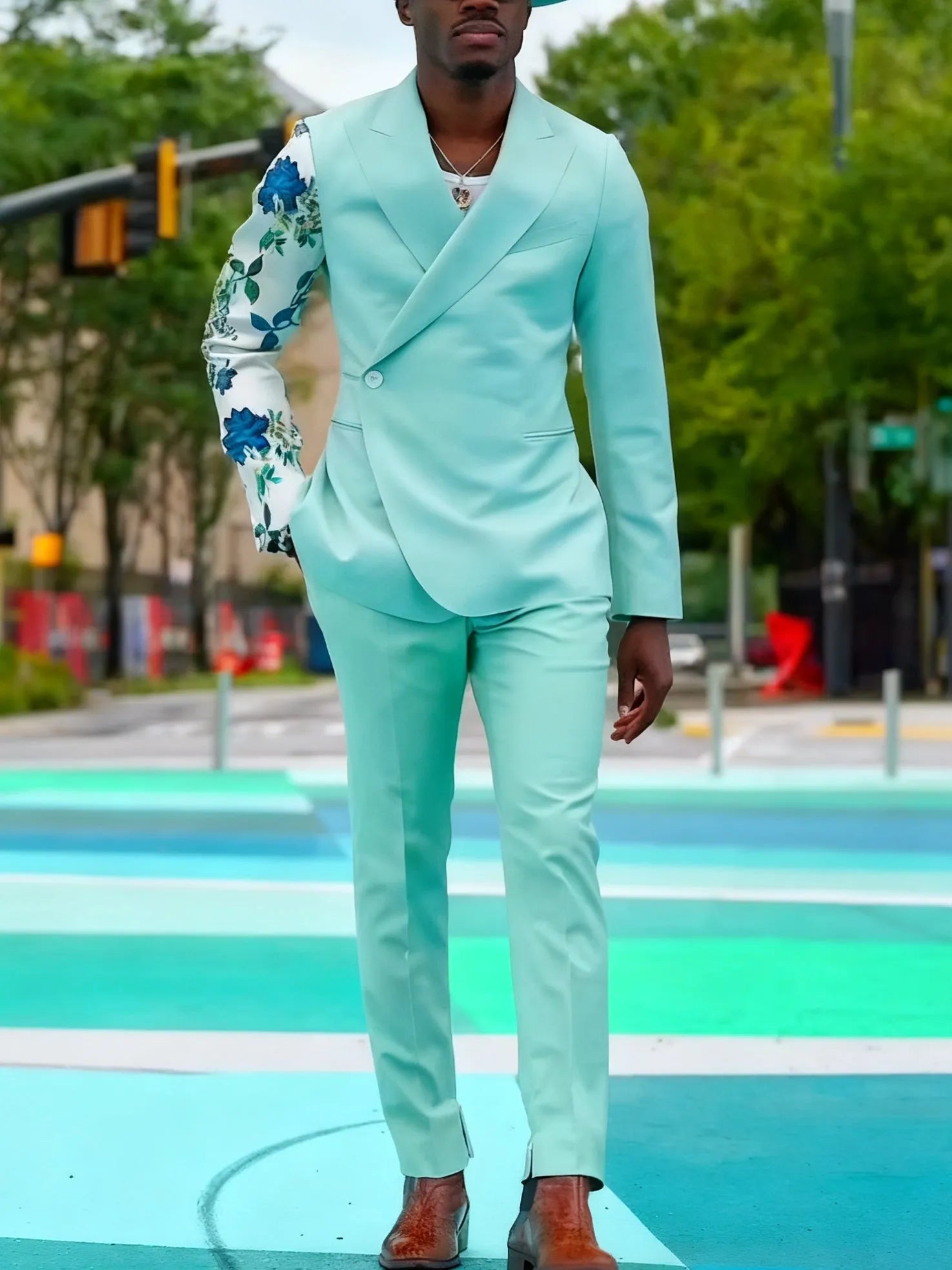 Mint green women's suit with double-breasted blazer and floral print sleeves, paired with ankle-length pants