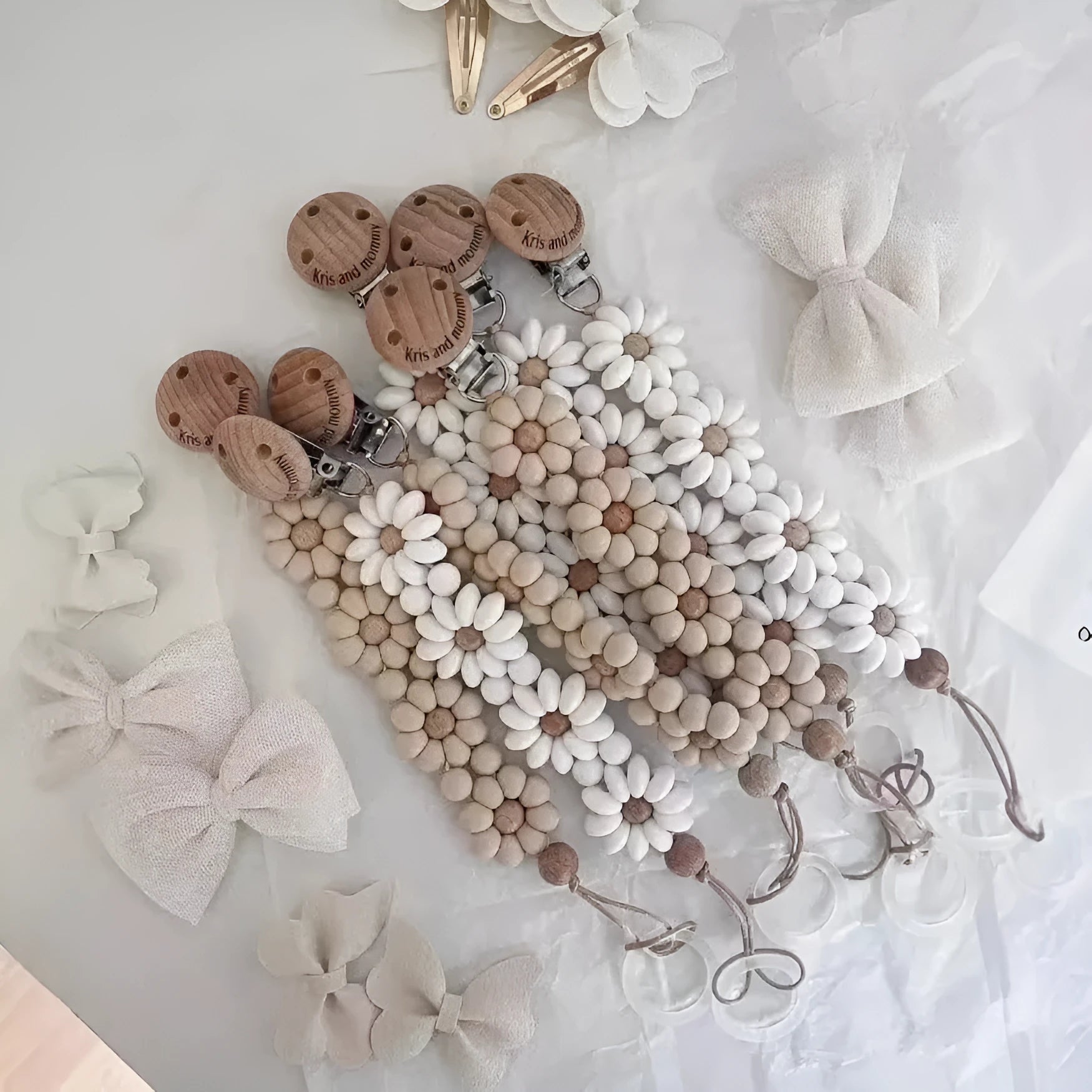 Silicone flower-shaped pacifier clip in Baby Pink with small beads and metal clip mechanism