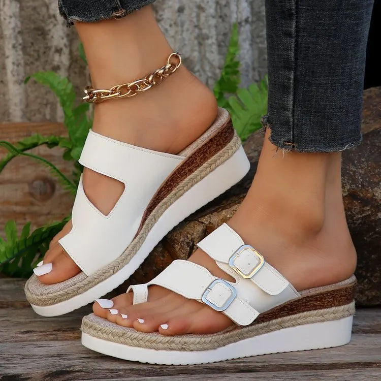 White women's wedge sandals with woven patent leather upper and peep toe.