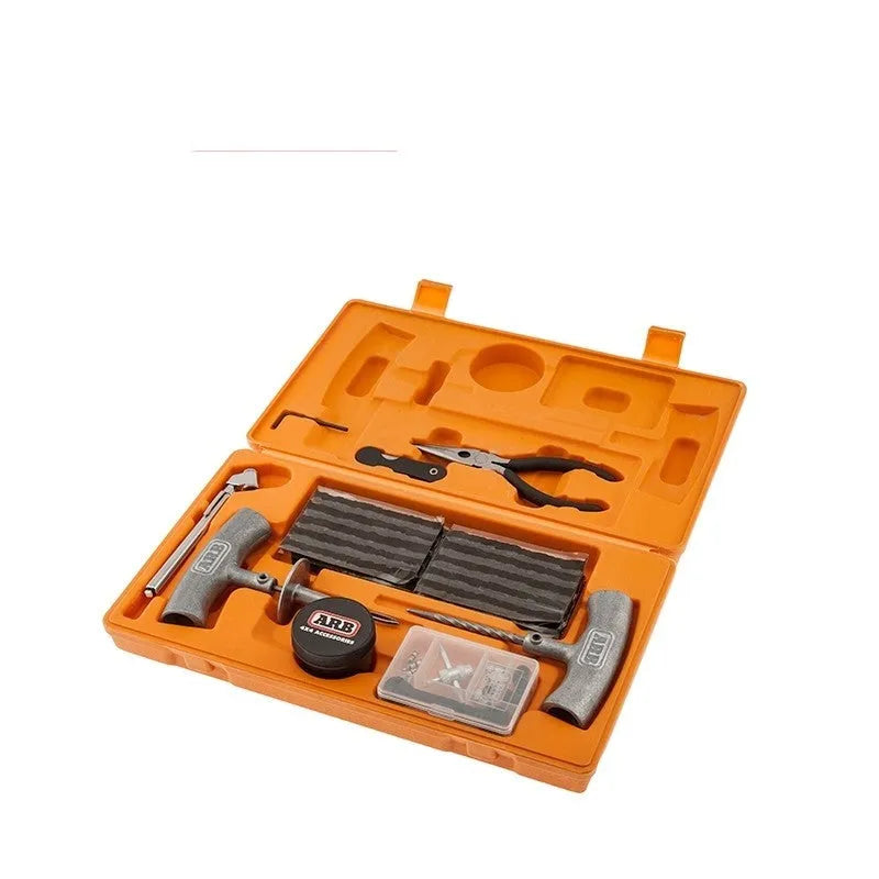 Emergency car tyre repair tool set with rubber strips, pressure gauge, and metal tools in a yellow case.