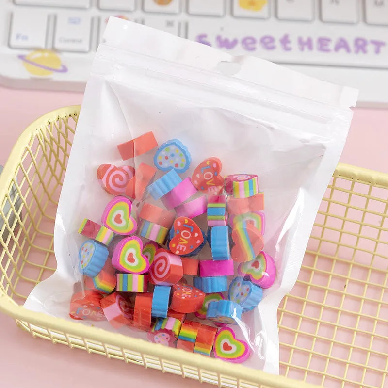 50 small colourful cartoon erasers featuring fruit, animal, cake, and theme designs in a pearlescent bag.