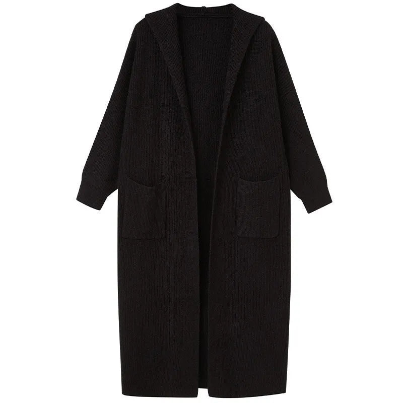 Long grey knitted women's cardigan with hood, modelled as a loose-fit trench coat.